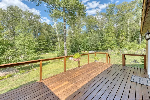 a view of balcony with wooden floor and fence