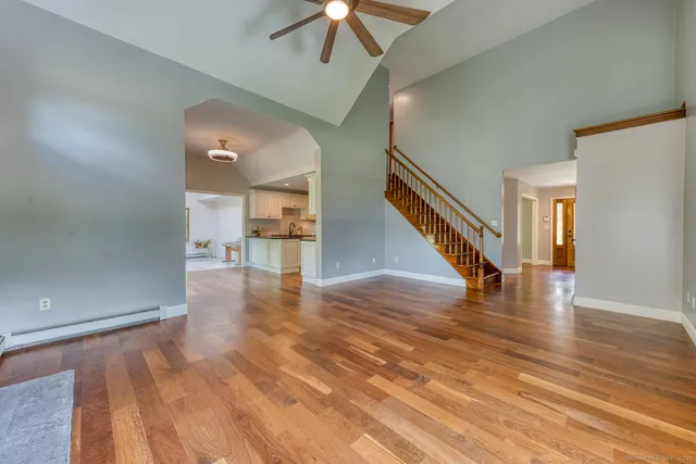a view of entryway and hall with wooden floor