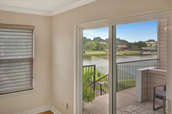 a view of a balcony with furniture and floor to ceiling window