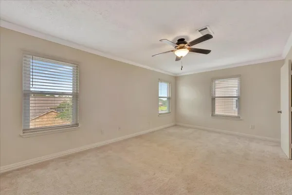 a view of a room with windows and a ceiling fan