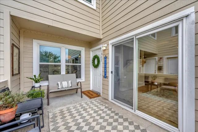 a view of a chair and tables in the balcony