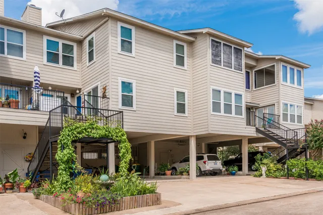 a view of a backyard with plants and outdoor seating