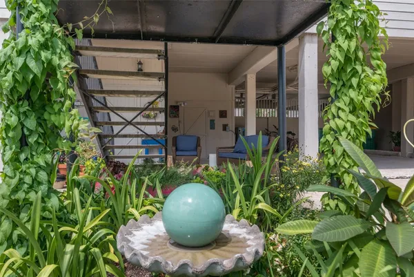 a view of a backyard with plants and outdoor seating