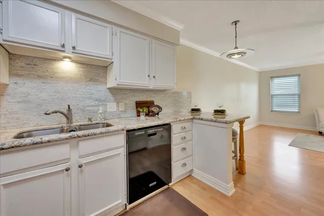 a kitchen with stainless steel appliances granite countertop a sink refrigerator stove and microwave