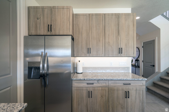 2972 West 570 North Hurricane, UT 84737 - Photo 40 of 104 Kitchen featuring light stone counters and stainless steel fridge with ice dispenser