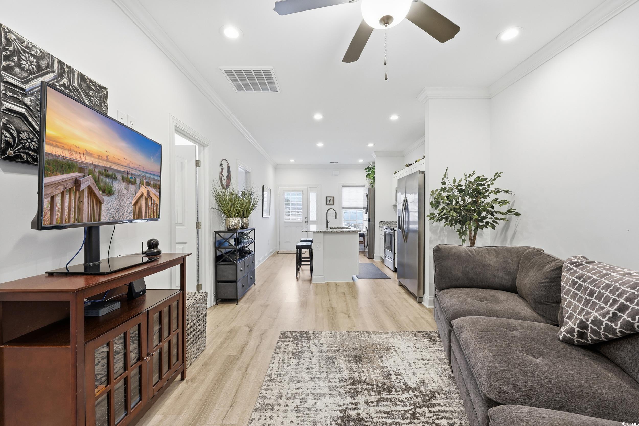 116 Kingsbury Loop, Unit C Conway, SC 29526 - Photo 10 of 32 Living area featuring crown molding, lvp floors, recessed lighting, and ceiling fan