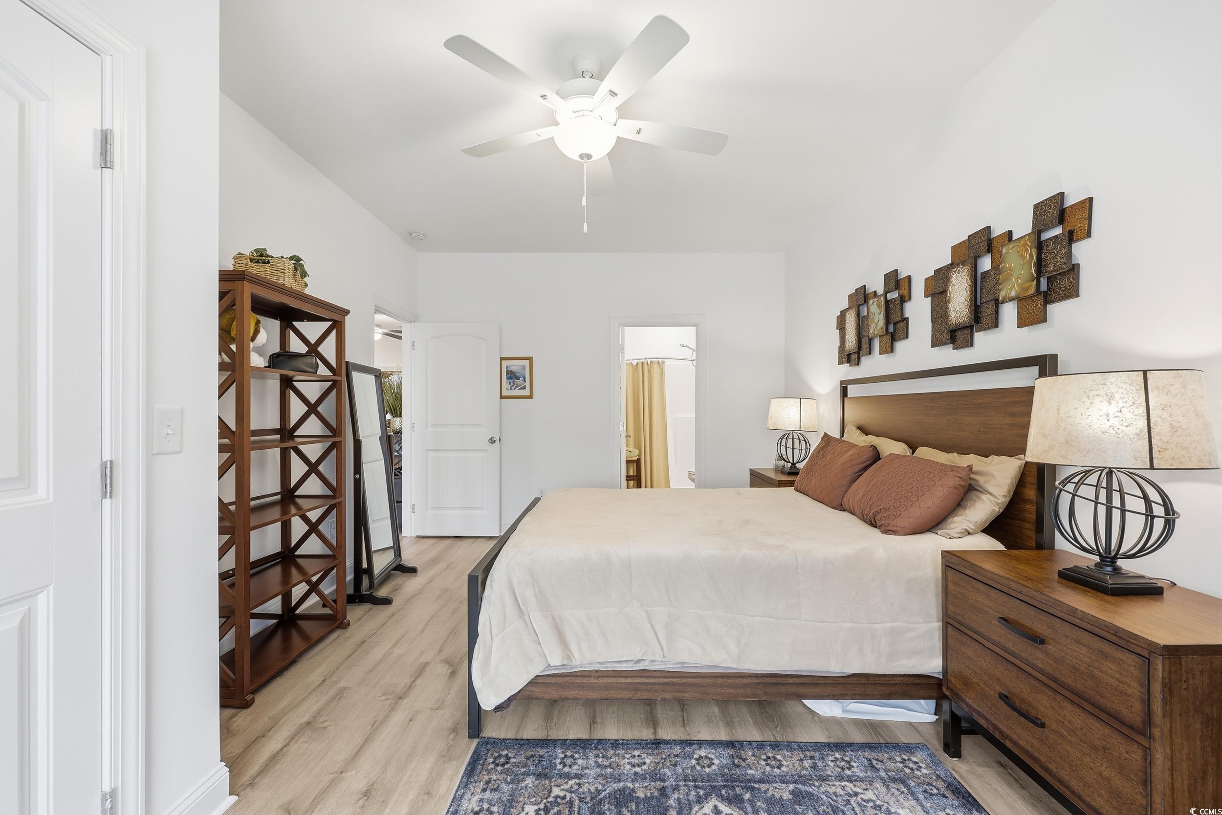 116 Kingsbury Loop, Unit C Conway, SC 29526 - Photo 12 of 32 Bedroom featuring lvp floors, a ceiling fan, and ensuite bathroom