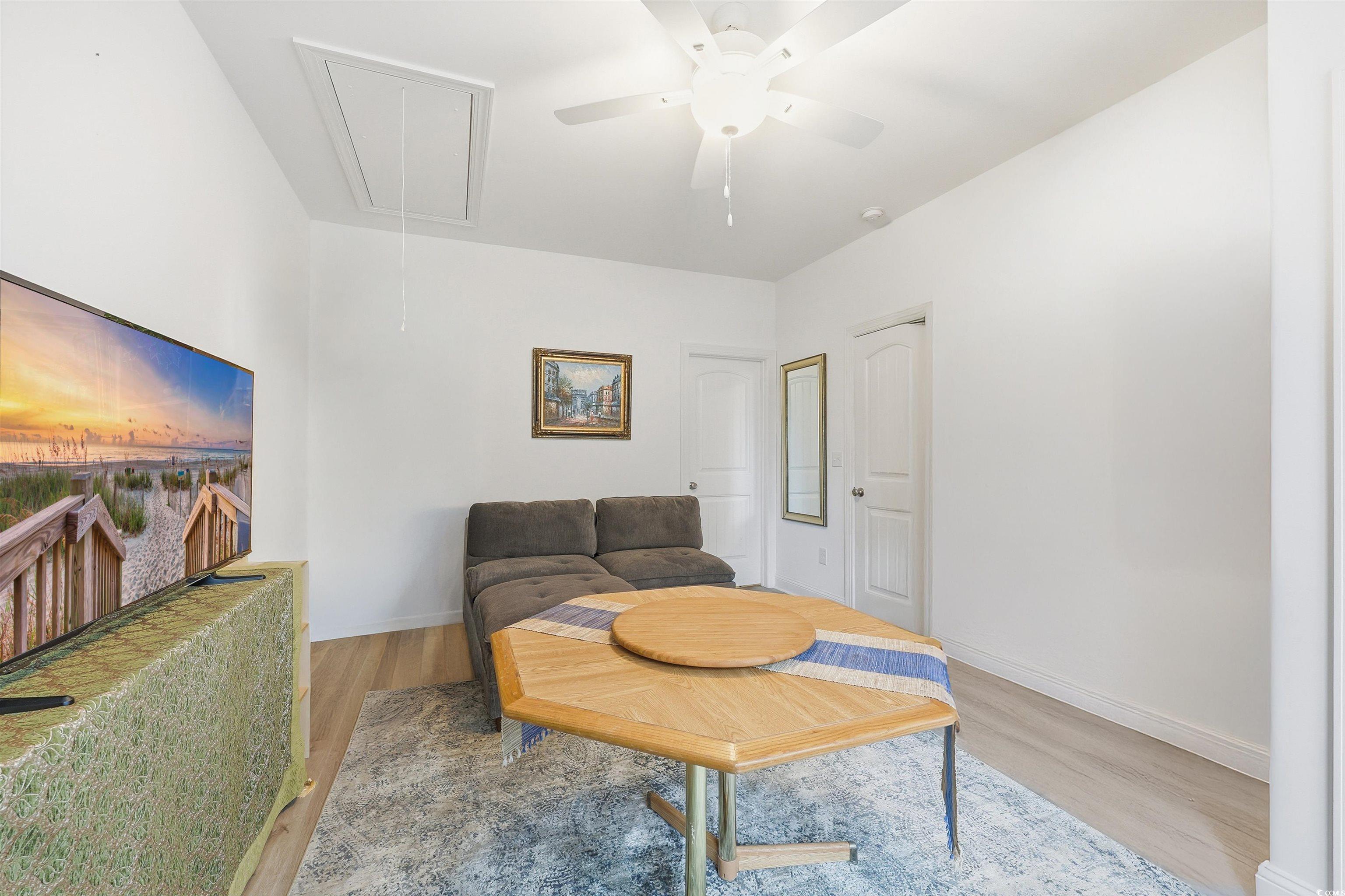 116 Kingsbury Loop, Unit C Conway, SC 29526 - Photo 16 of 32 Bedroom featuring attic access, a ceiling fan, and lvp. Some furniture has been digitally removed to better show the space. *original photos included