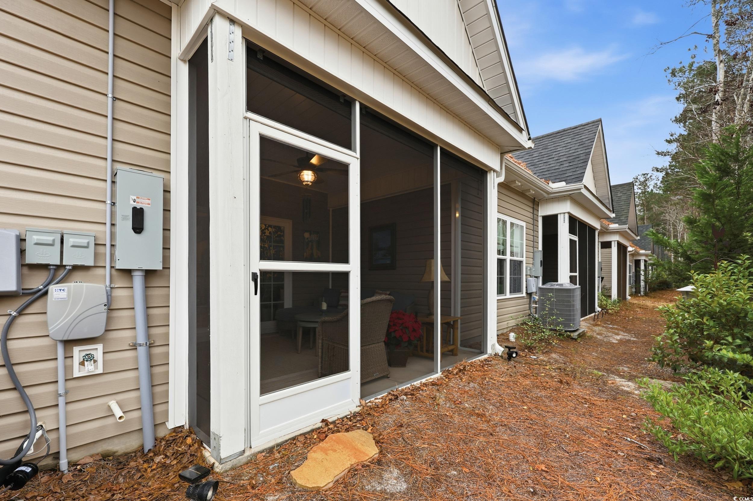 116 Kingsbury Loop, Unit C Conway, SC 29526 - Photo 23 of 32 View of home's exterior featuring a sunroom and a shingled roof