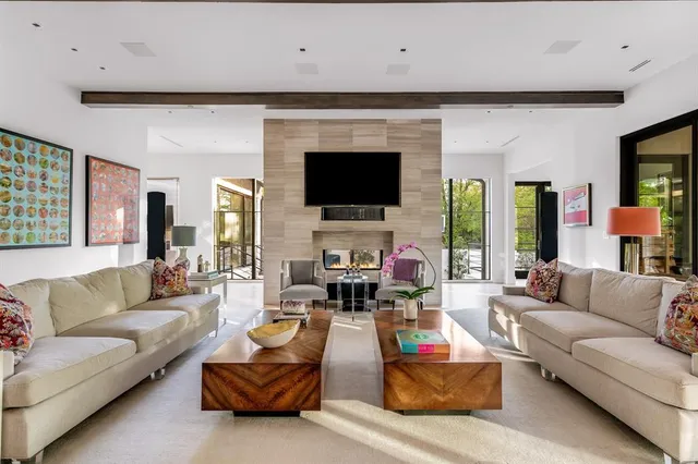 a living room with fireplace furniture and a flat screen tv