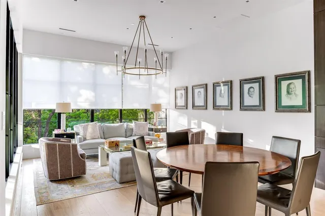 a dining room with furniture a chandelier and window