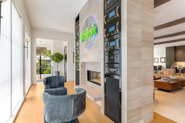 a living room with furniture a fireplace and a large window