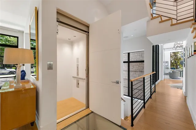 a view of a hallway with workspace and a window