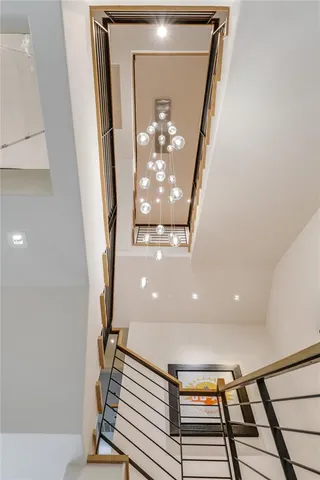 a view of a hallway with wooden floor and staircase