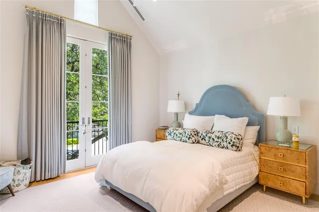 a bed sitting in a bedroom next to a window