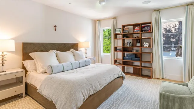 a bedroom with a bed and a book shelf