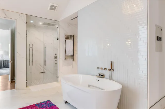 a bathroom with a bathtub and a shower