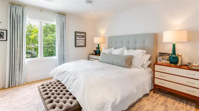 a bedroom with a bed and a large mirror