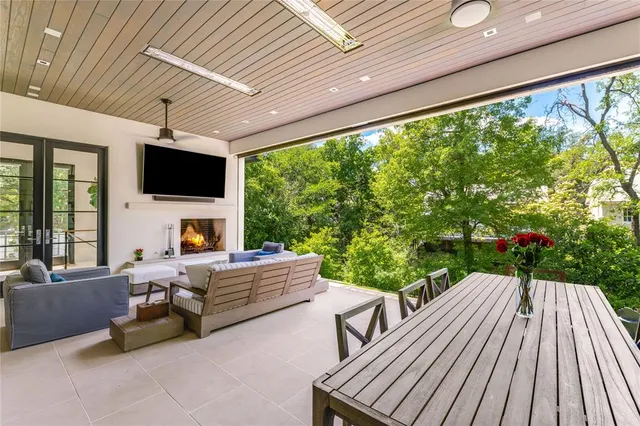 a living room with patio furniture and a fireplace