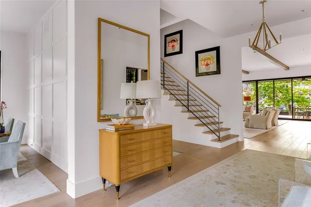 a view of a livingroom with furniture staircase and front door