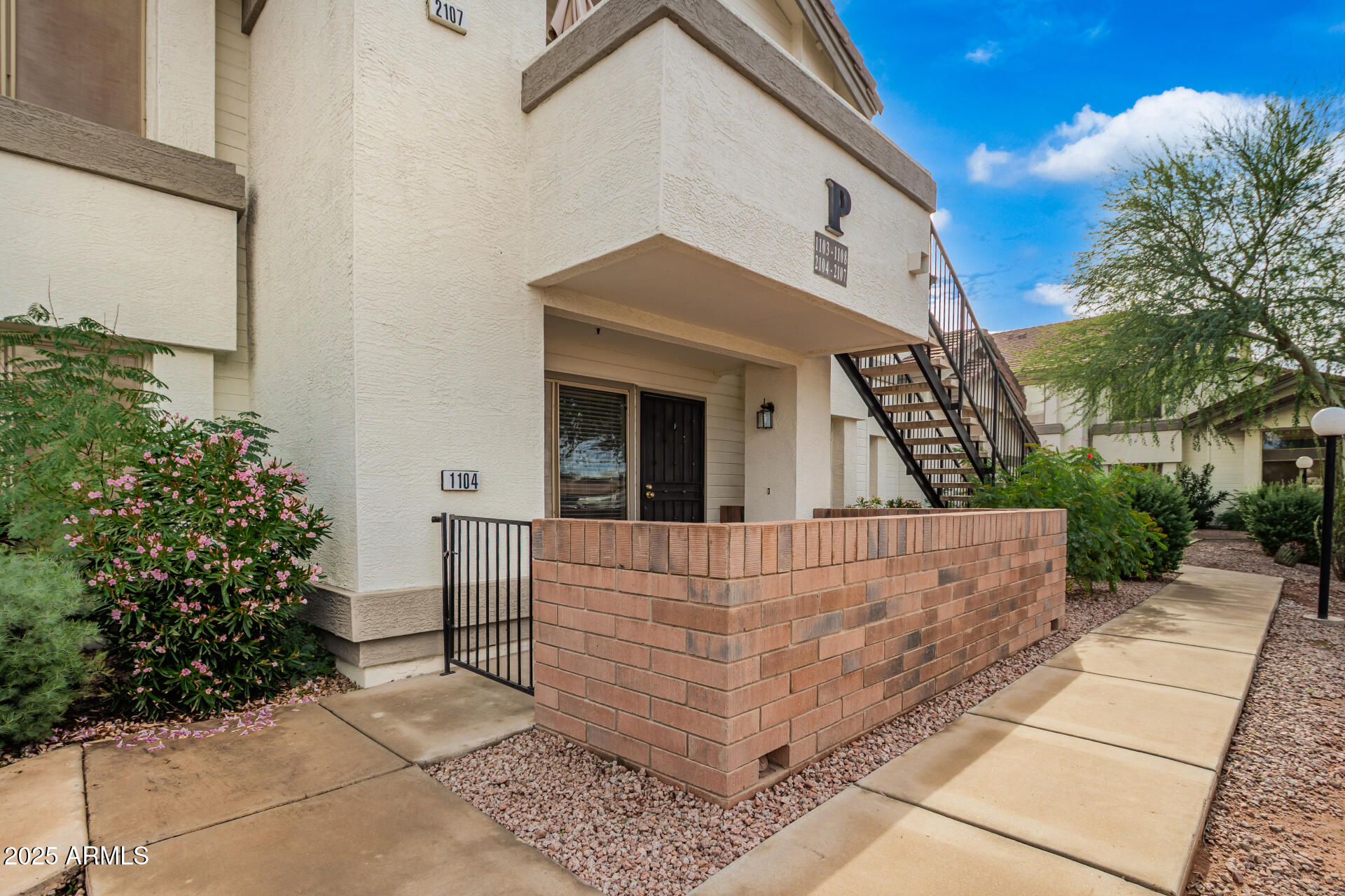 2201 North Comanche Drive, Unit 1104 Chandler, AZ 85224 - Photo 1 of 25 a view of a house with a yard and potted plants