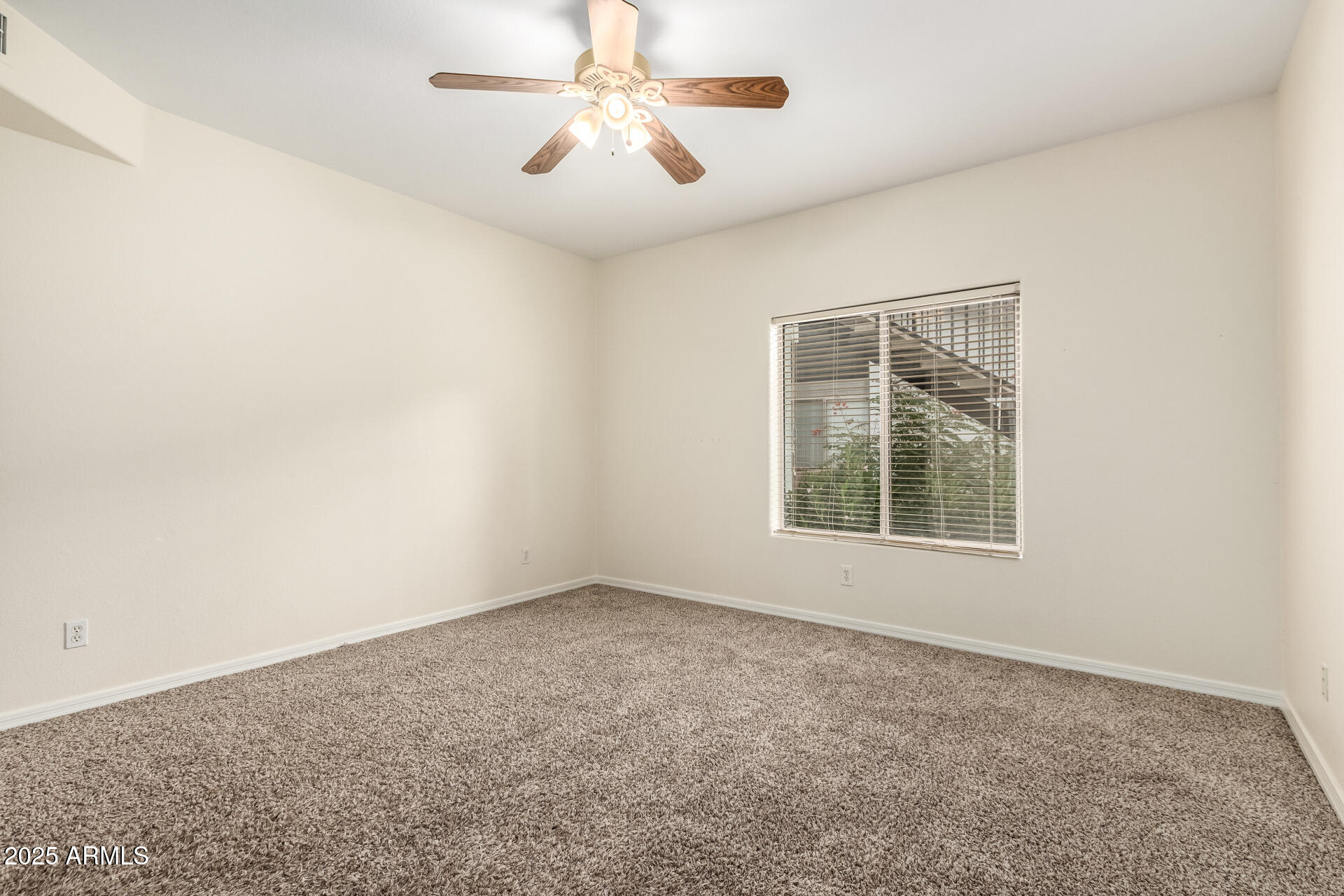 2201 North Comanche Drive, Unit 1104 Chandler, AZ 85224 - Photo 12 of 25 an empty room with a window and a fan