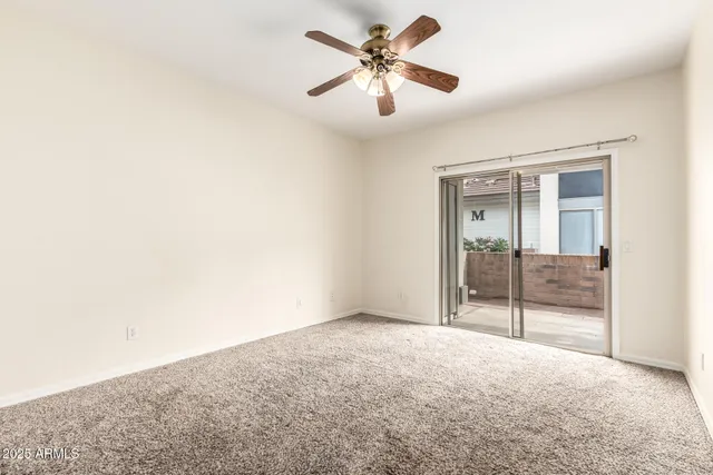 a view of empty room with ceiling fan