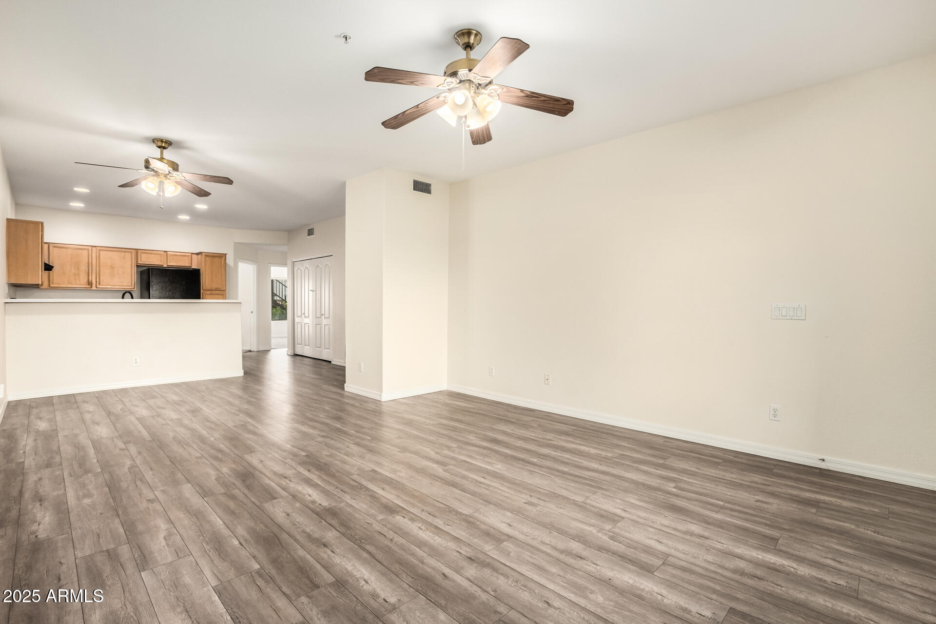 2201 North Comanche Drive, Unit 1104 Chandler, AZ 85224 - Photo 6 of 25 wooden floor in an empty room with a window