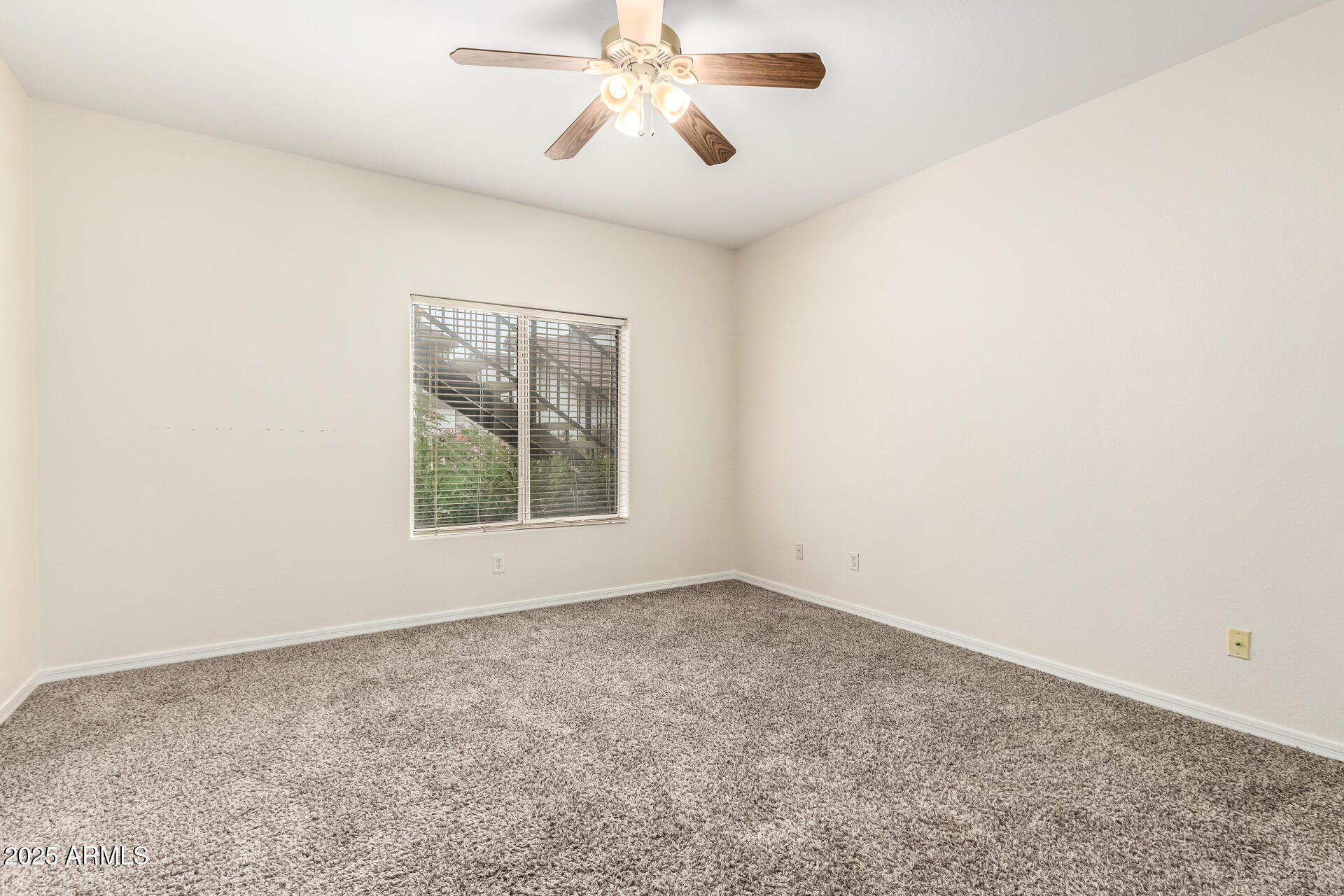 2201 North Comanche Drive, Unit 1104 Chandler, AZ 85224 - Photo 10 of 25 an empty room with windows and fan