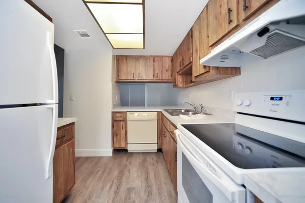 a kitchen with a cabinets and wooden floor