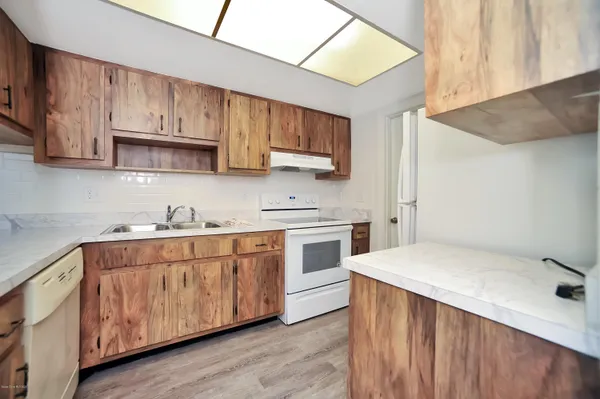 a kitchen with stainless steel appliances a sink a stove and cabinets