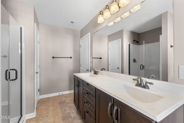 a bathroom with a sink double vanity and a mirror