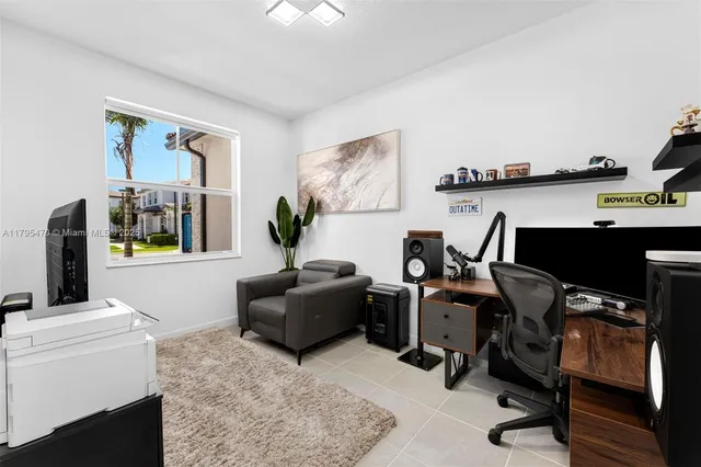 a view of a workspace with furniture and a window