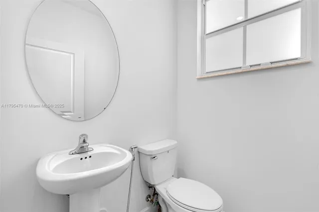 a bathroom with a sink a mirror and a toilet