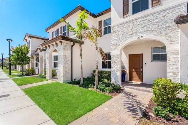 front view of a house with a small yard