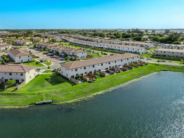 an aerial view of a house with a garden and mountain view in back