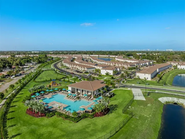 an aerial view of residential houses with outdoor space and swimming pool