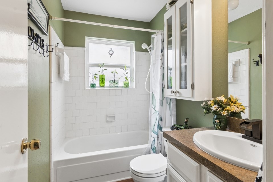 9211 Benwick Street Spring, TX 77379 - Photo 22 of 27 a bathroom with a granite countertop sink toilet and shower