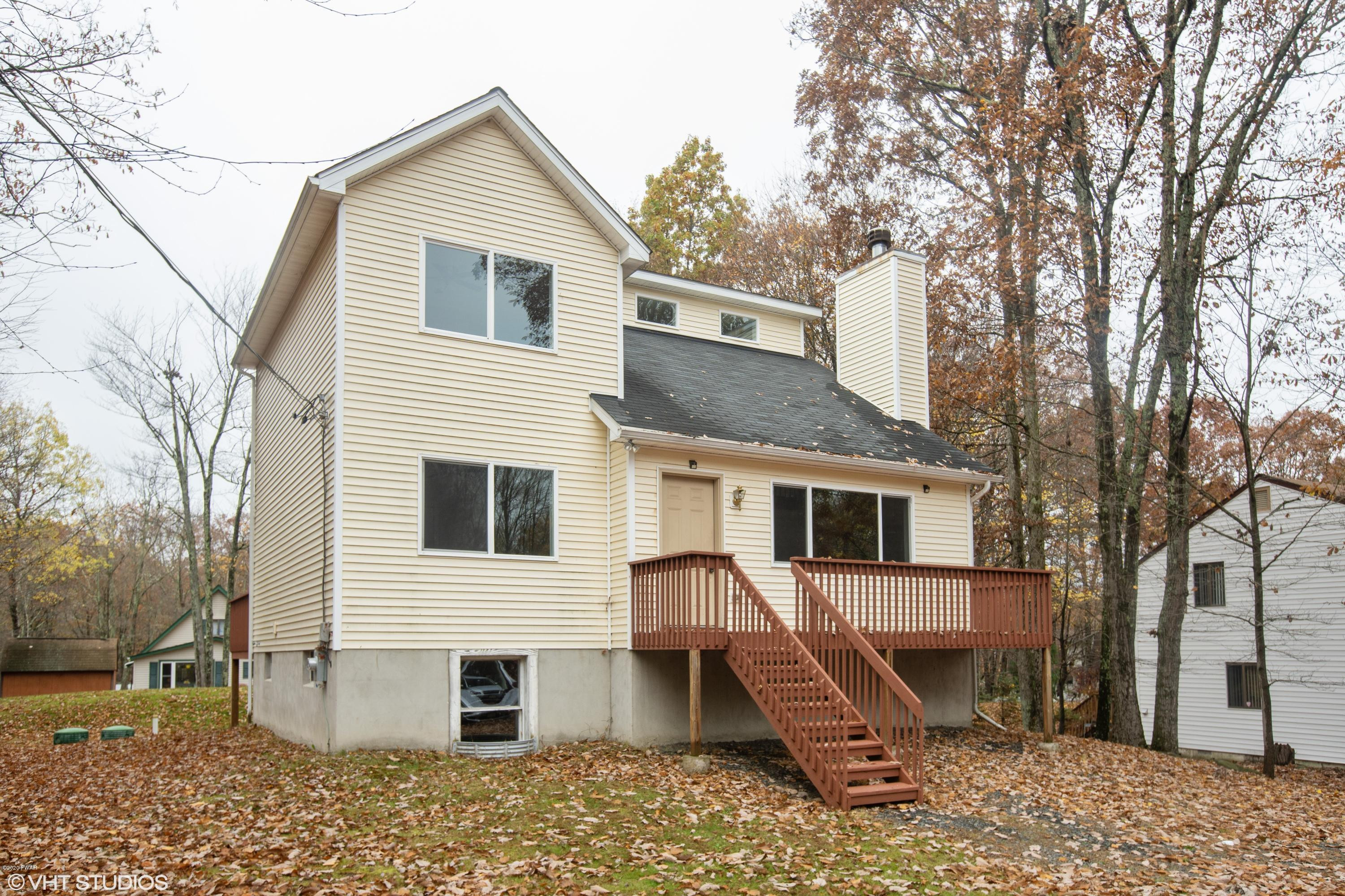 133 Roundhill Road Dingmans Ferry, PA 18328 - Photo 2 of 12 a view of a house with a yard
