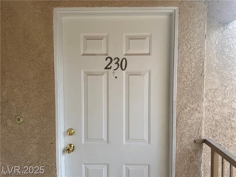 1830 North Pecos Road, Unit 230 Las Vegas, NV 89115 - Photo 3 of 16 Secure entry provides peace of mind within a textured exterior setting.