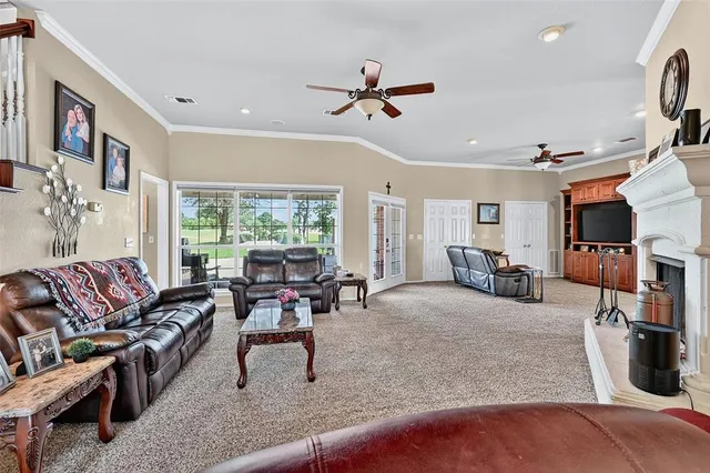 a living room with furniture fireplace and a large window