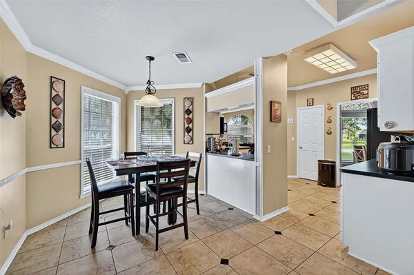 a view of a dining room with furniture and chandelier