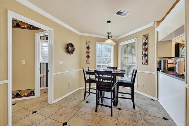 a view of a dining room with furniture and chandelier