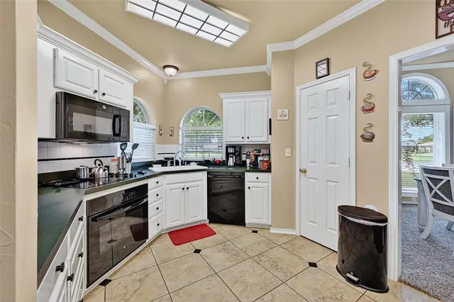 a kitchen with stainless steel appliances kitchen island granite countertop a refrigerator stove and sink