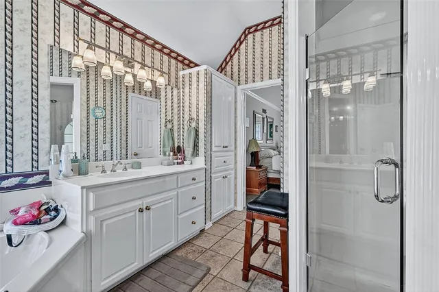 a bathroom with a double vanity sink and a shower