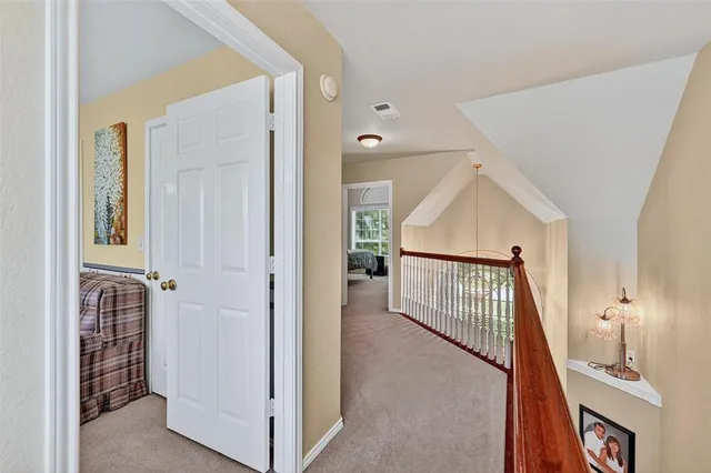a view of a hallway with a white door and stairs