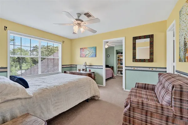 a bedroom with a bed and glass window