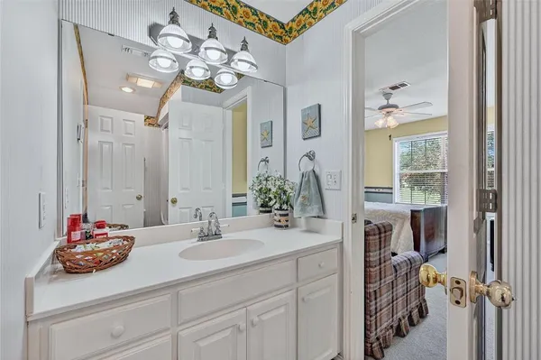 a bathroom with a sink a vanity and a mirror