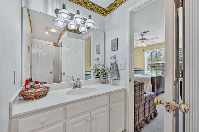a bathroom with a sink a vanity and a mirror