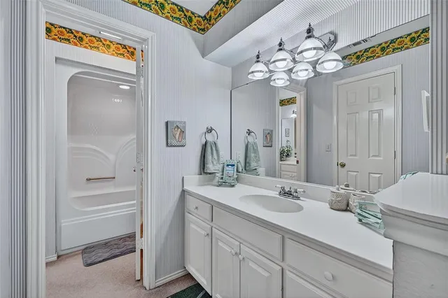 a bathroom with a sink a vanity and a mirror